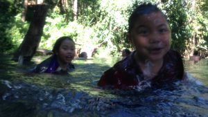 Children playing in the Sai Ngam hot spring